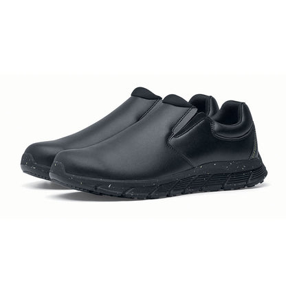 The Shoes for Crews Cater Eco Women's  Black is a sustainable, slip-resistant safety shoe, pair seen in profile on the left.