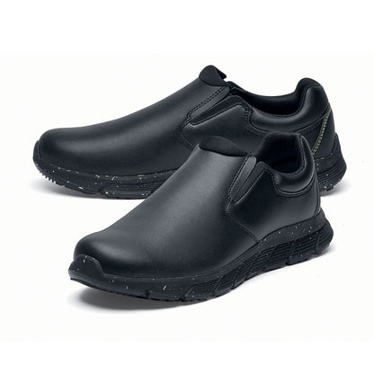 The Shoes for Crews Cater Eco Women's  Black is a sustainable, slip-resistant safety shoe, pair seen from the left  side, emphasised on the tip of the left shoe.