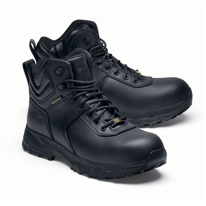 The Guard Mid from Shoes For Crews are waterproof slip-resistant safety boots with a safety toe cap, pair seen from the right side, emphasised on the tip of the right shoe.